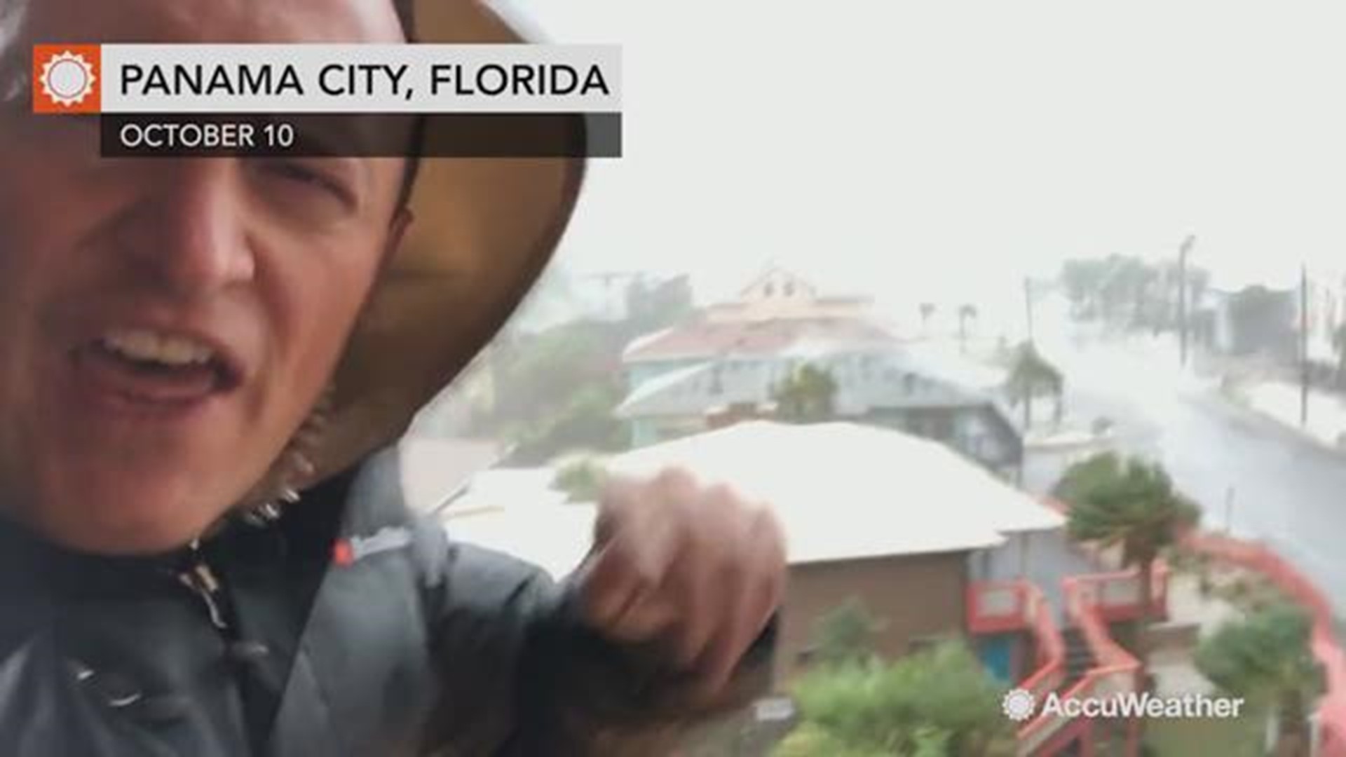 AccuWeather's Jonathan Petramala films as shingles are ripped from their roofs as Hurricane Michael's eyewall tears through Panama City, Florida.