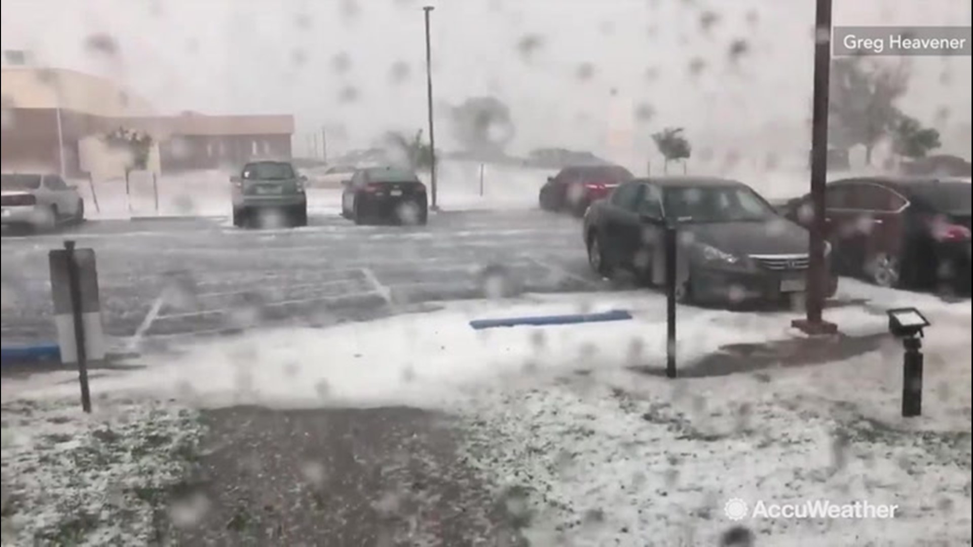 A passing storm dumped small hail in Pueblo, Colorado on June 17, making the parking look like it was just hit by winter storm.
