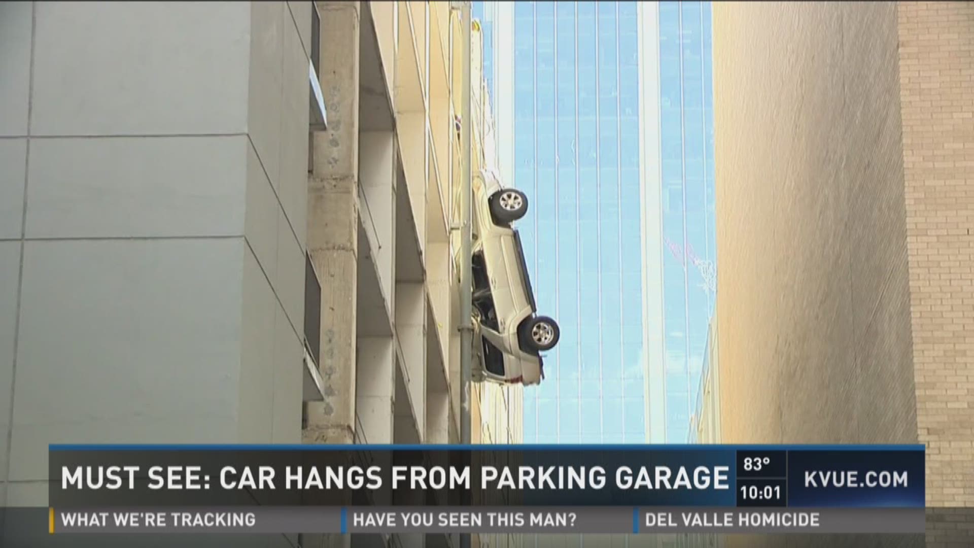 Must see: Car hangs from parking garage