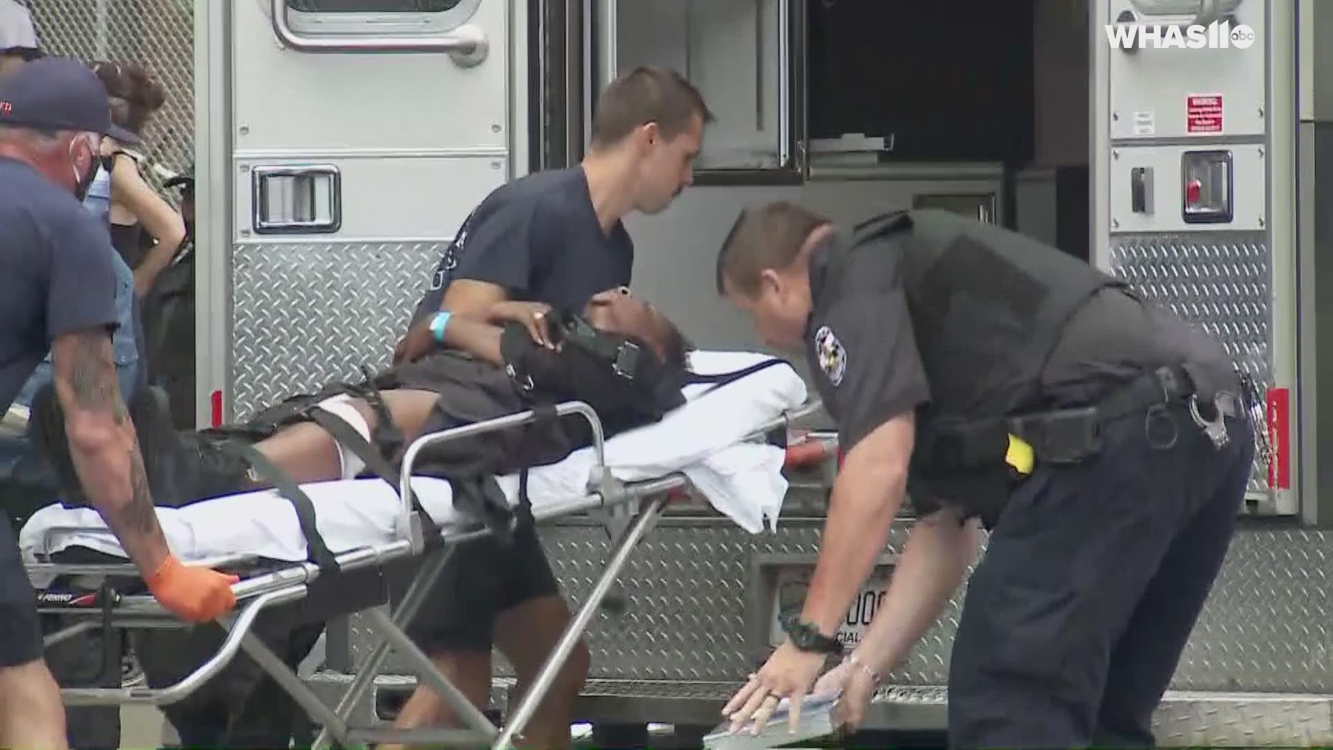 WHAS journalists on scene watched LMPD confiscate a gun from members of the NFAC following the shooting.