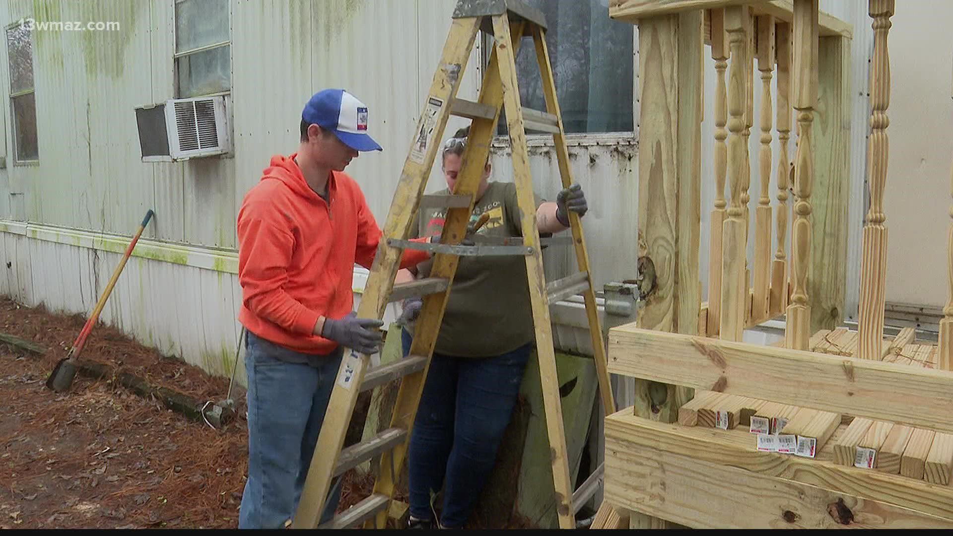 Students came down from Bowling Green, Kentucky to Americus. They're working on resealing a home's roof.