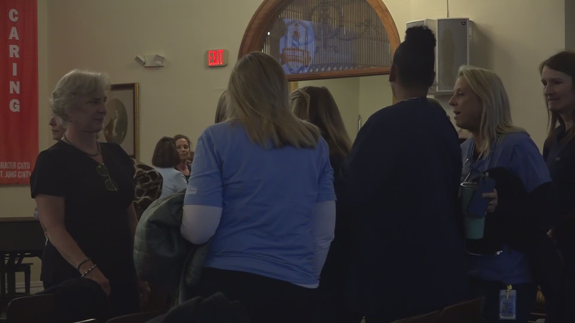 Dozens of nurses showed up wearing scrubs in a show of solidarity at the Tuesday night school board meeting.