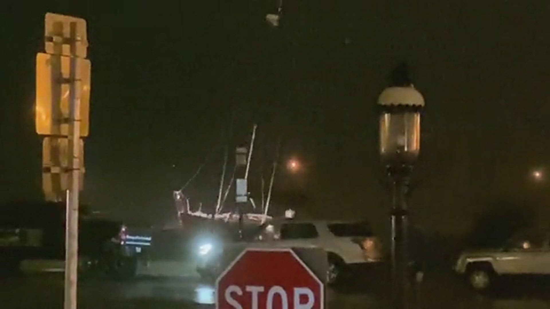 A loose sailboat is being slammed against the seawall in St. Augustine during Tropical Storm Ian.