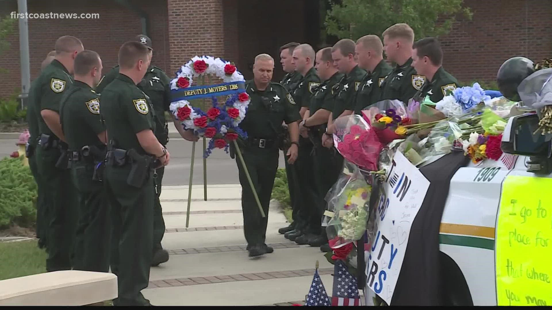 On Friday, Moyers' team added a blue and white wreath to the memorial that’s been forming around his patrol car outside the sheriff’s office.