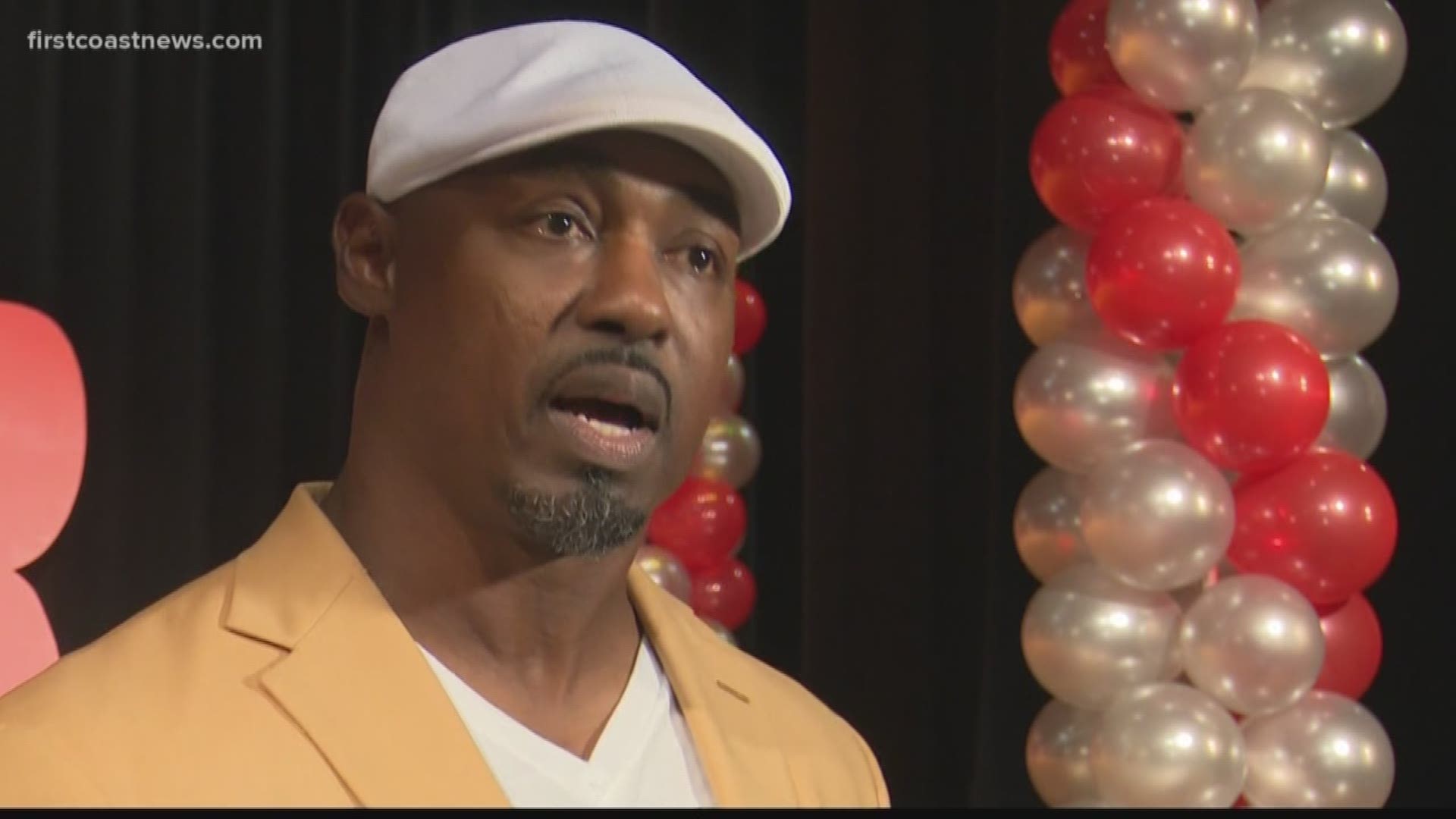 Former athlete Brian Dawkins visited Raines High School, a school he played for as a teen, to inspire students affected violence.