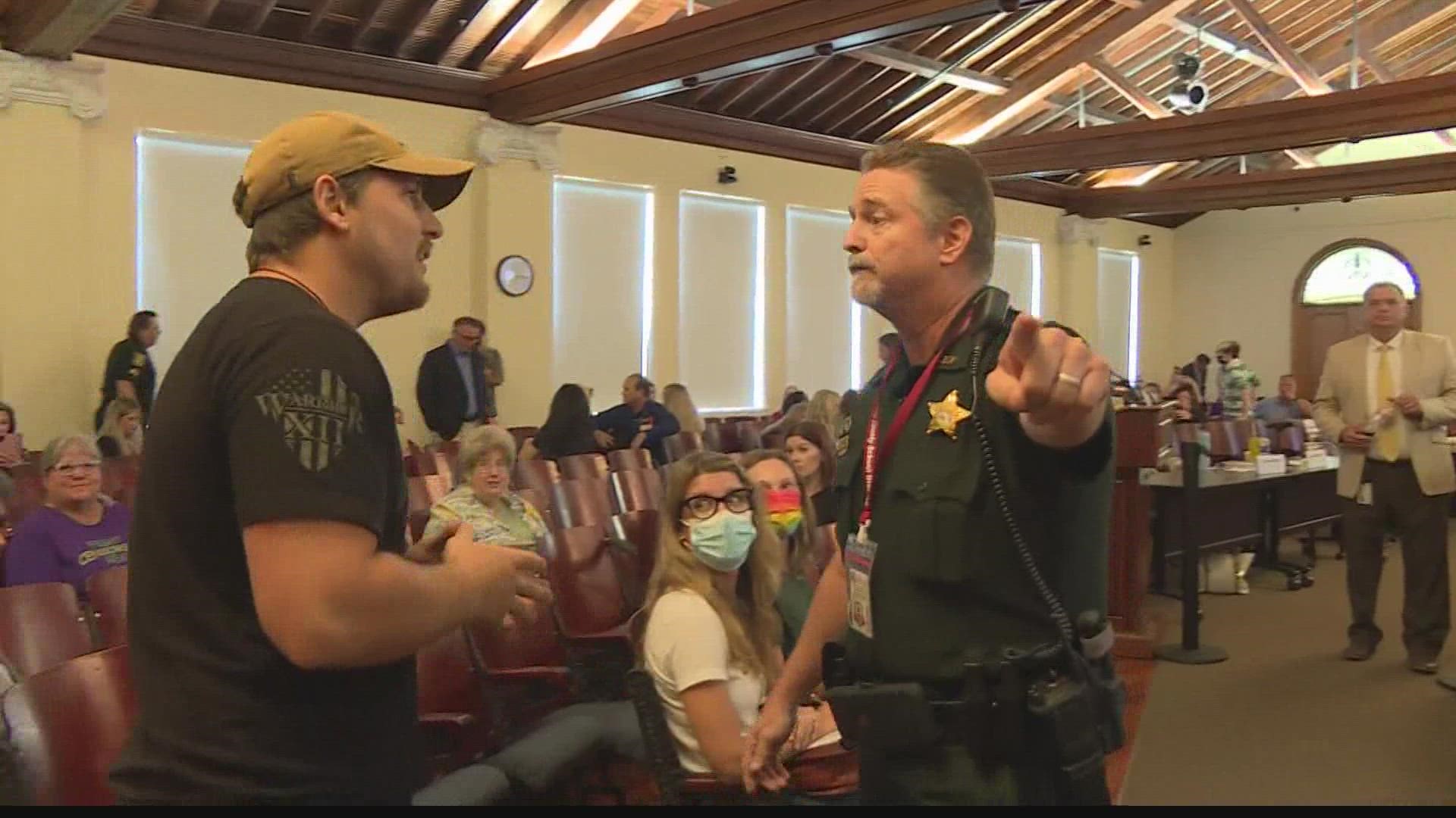 Deputies had to escort unruly individuals out of school board meeting related to a 'no' vote on banning seven books with LGBTQ and racial subject matter