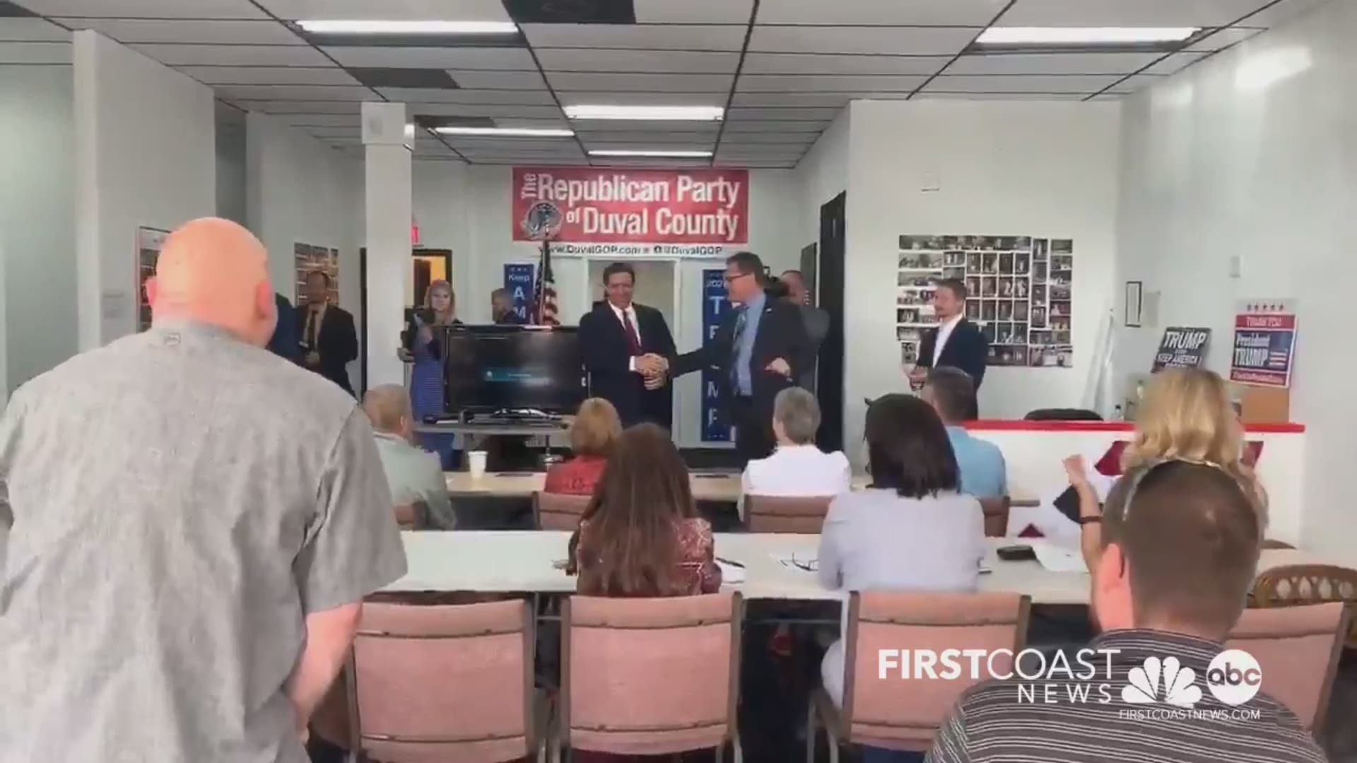 Florida Gov. Ron DeSantis surprised a group of Duval County Republican volunteers Wednesday with a bunch of "Keep America Great" hats signed by President Trump.