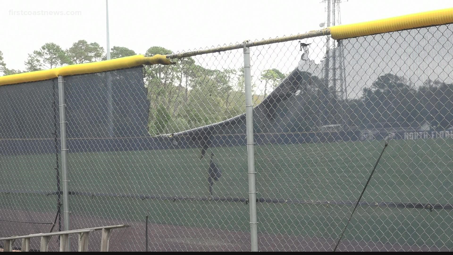 When officers arrived on scene they found a portion of the left-field wall, netting and a ladder in the area on fire.