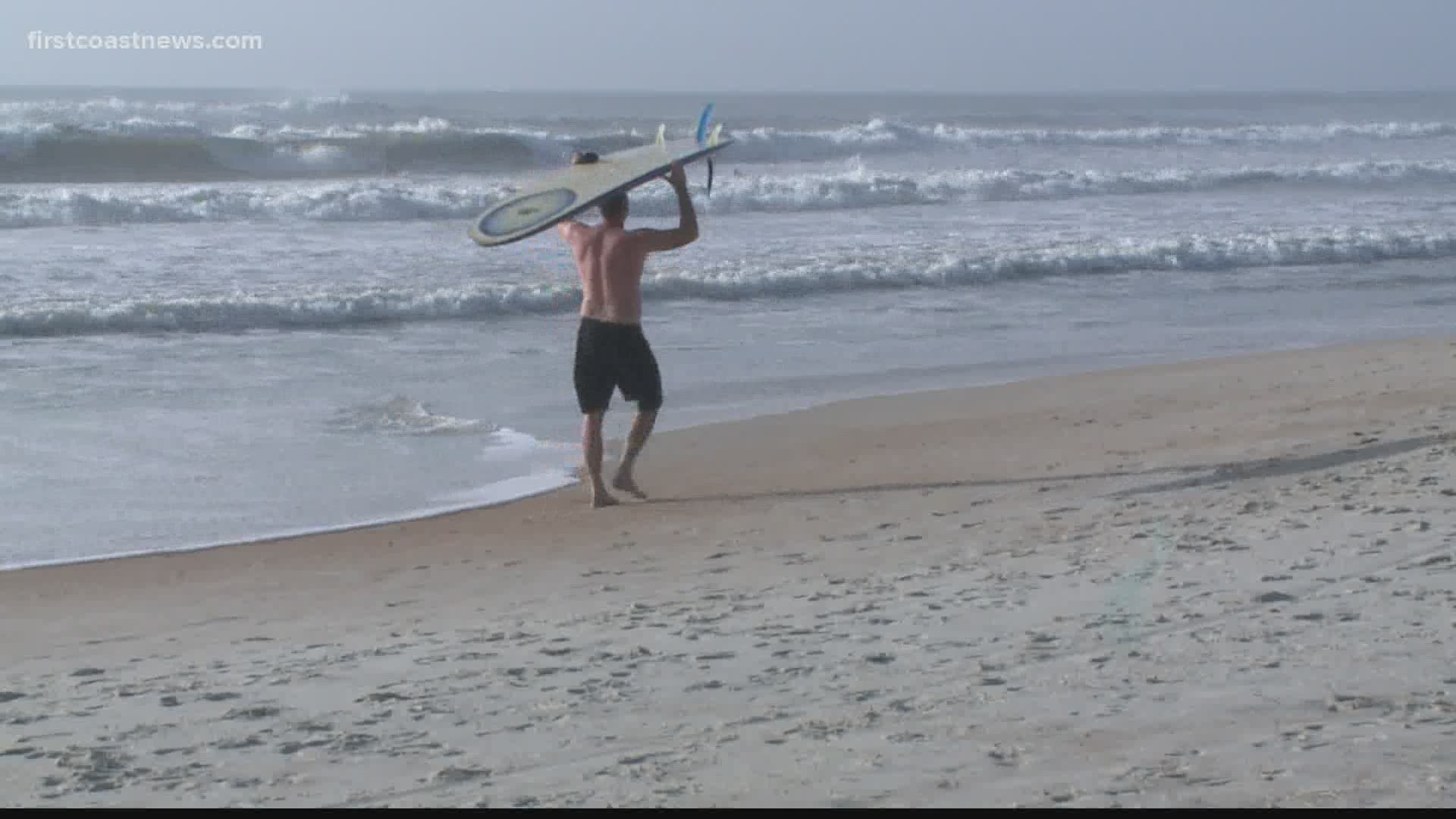 Despite large swells, surfers are being warned to stay out of the water as Isaías approaches.