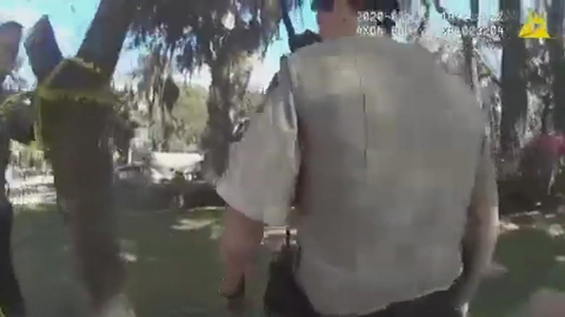 At one point, Gregory McMichael shows the officer his hands. The left one has blood on them, the video shows. WARNING: Viewer discretion advised.