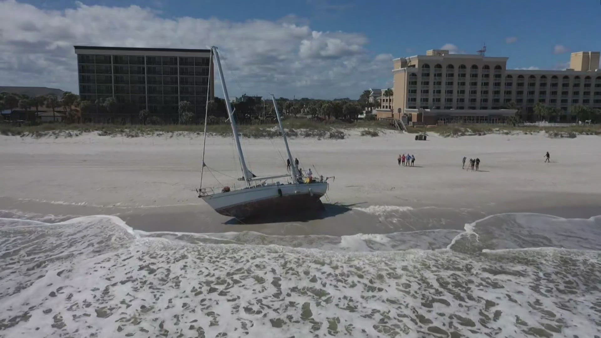 A captain and his sailboat are stranded on Jacksonville Beach after he says the vessel lost power, forcing him to swim to shore.