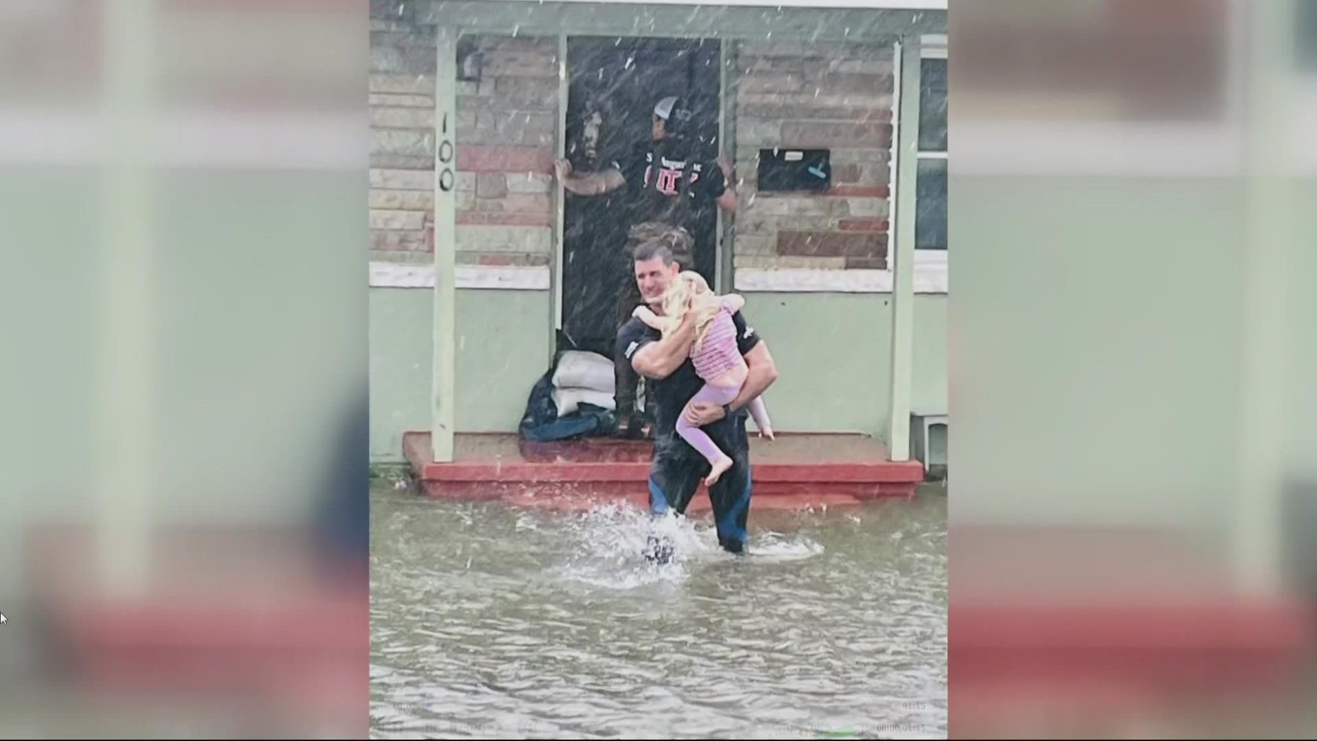 A photo shows Hardus Oberholzer saving a little girl, one of 26 rescues in St. Augustine. He say it will stick with him forever.