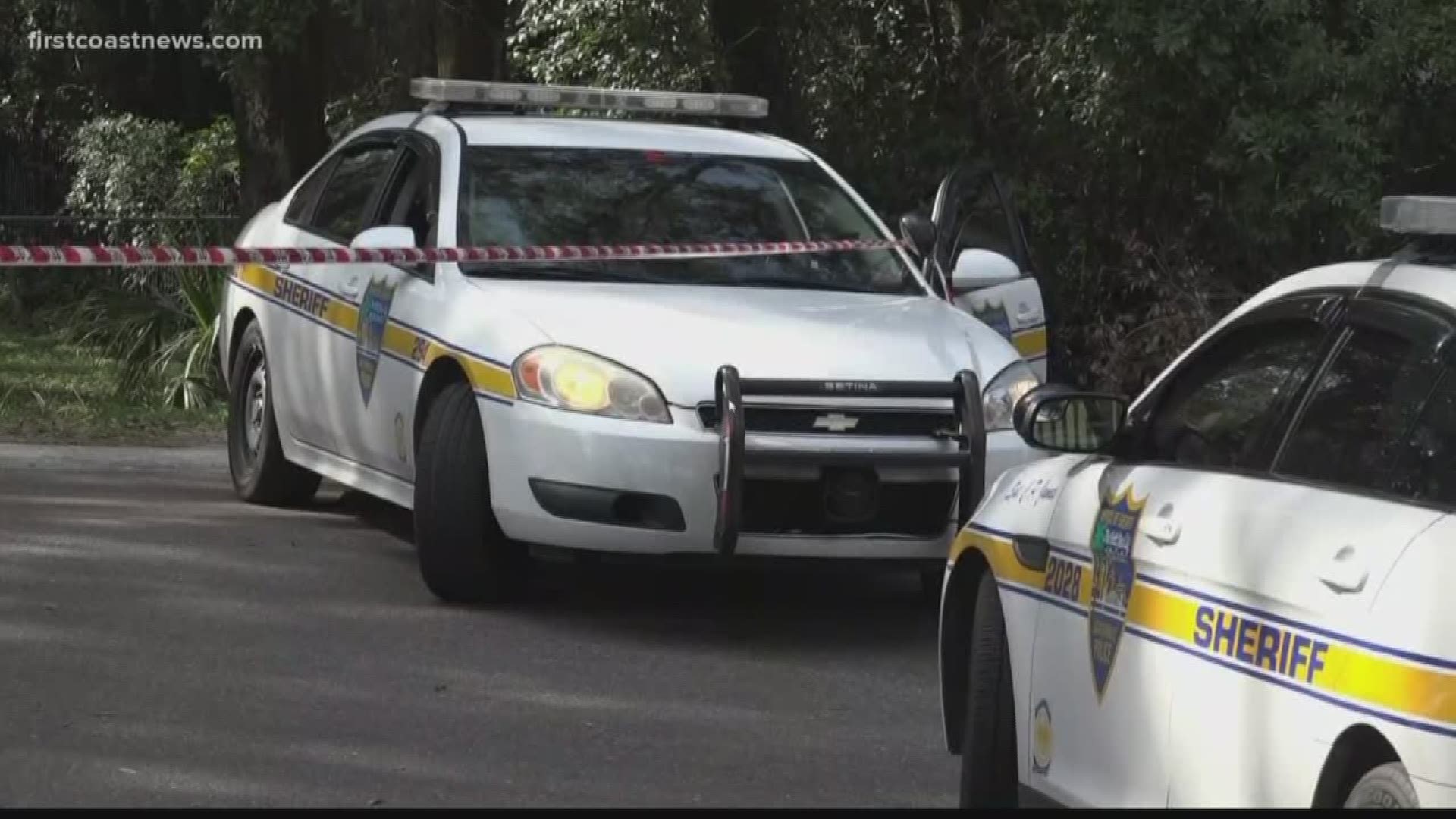 A woman was unharmed after her vehicle was caught in the crossfire of a shooting in Arlington and rolled into a ditch Wednesday, the Jacksonville Sheriff's Office told First Coast News.