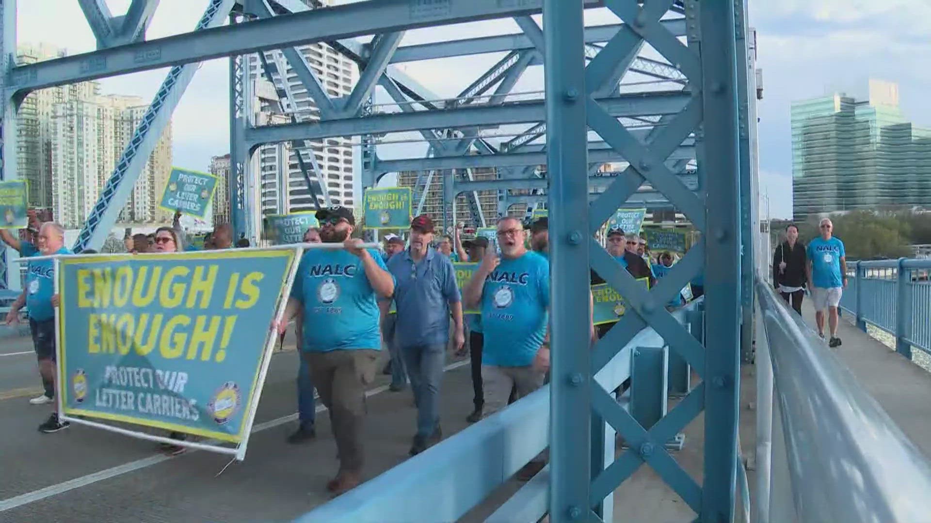 About 300 letter carriers chanted "Enough is Enough" to protest against violence against the profession.