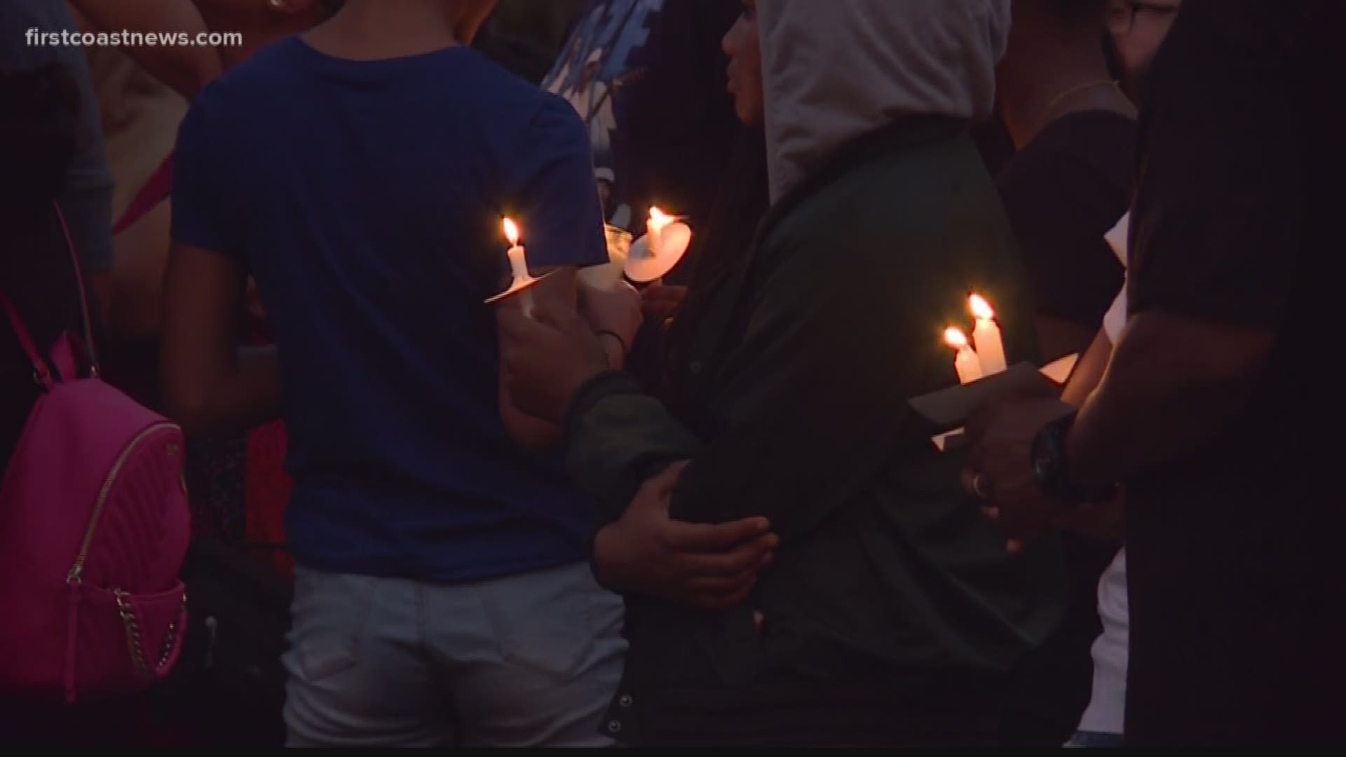 Classmates, community members and loved ones lit candles and prayed at the crash site where 16-year-old Keondre Moss died when the car he was in crashed into a tree.