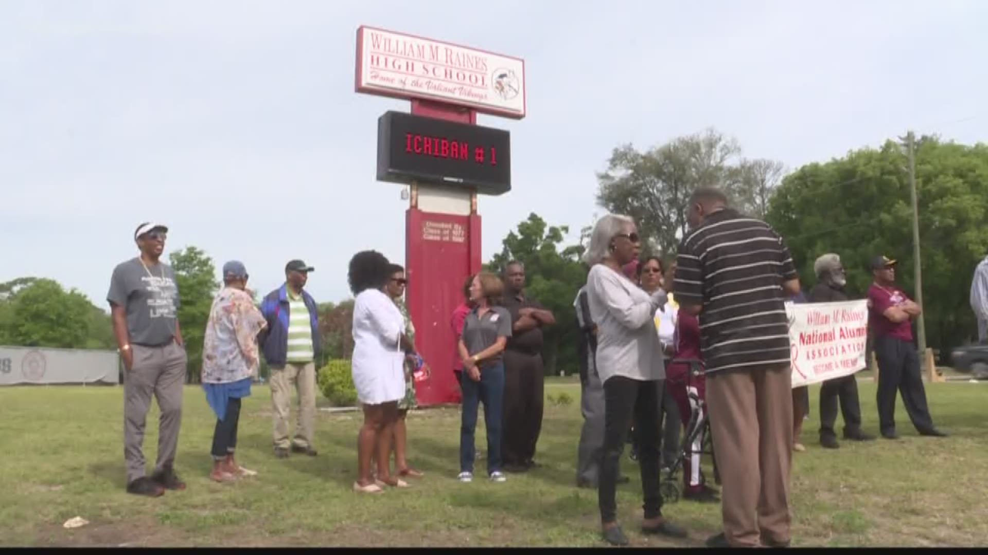 Alumni from decades of Raines gathered outside the school with the message to 'say no to Raines 6-12'.