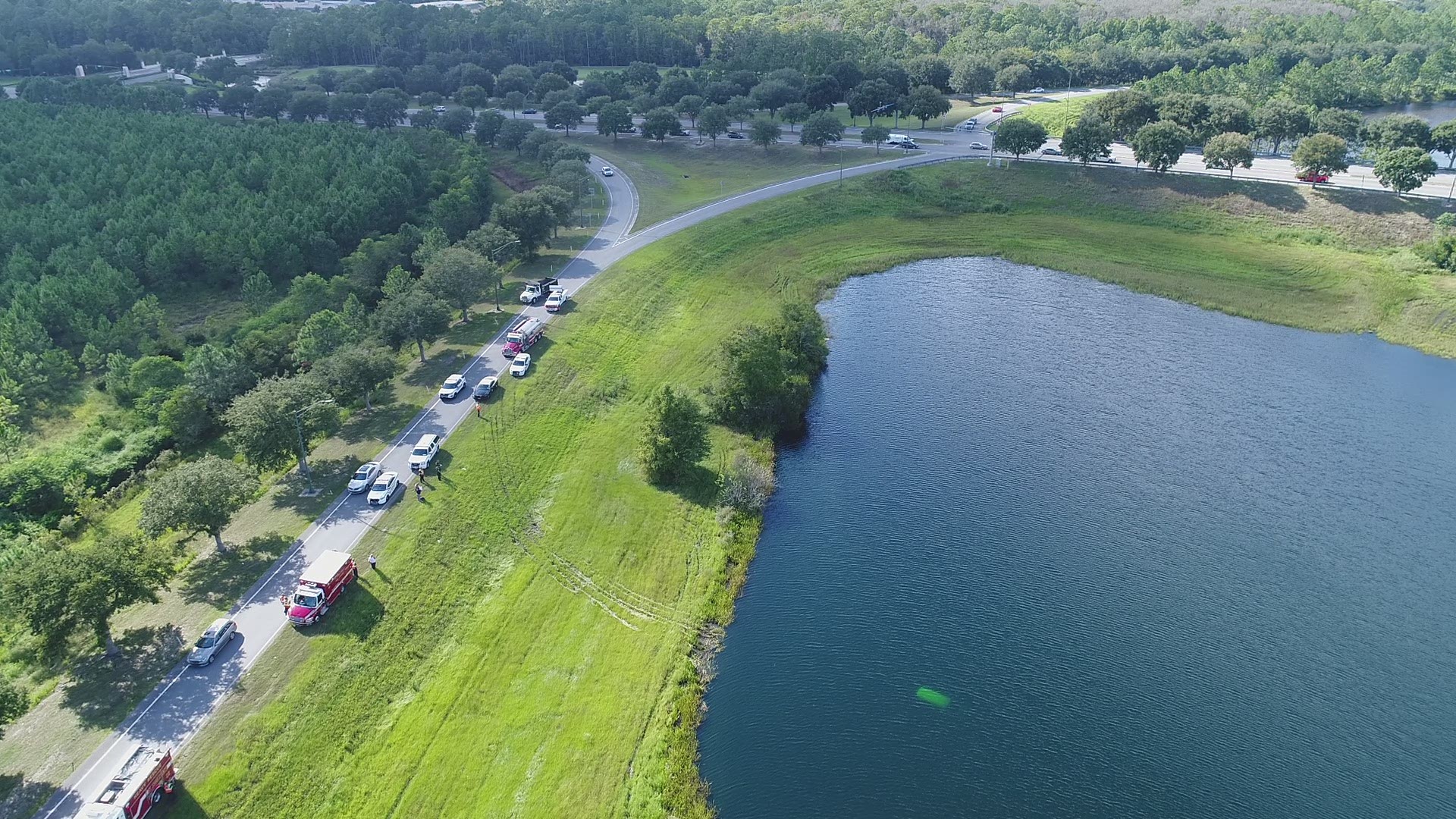 Two cars, and a total of four people, ended up in a pond near the exit for World Golf Village. All four people were able to exit their vehicles.