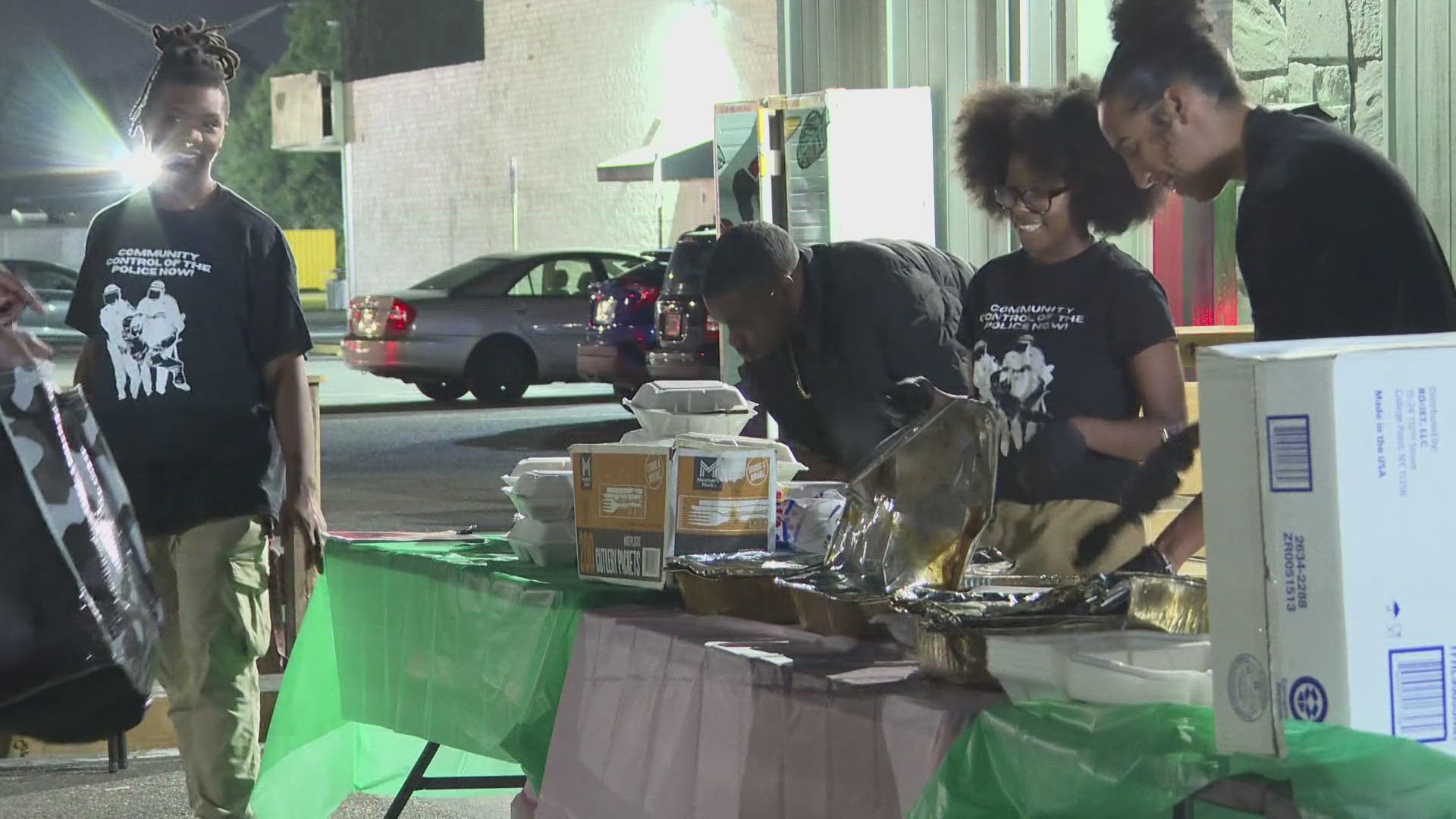 Outside Café Resistance on Soutel Drive, members with the Jacksonville Community Action Committee (JCAC) spent the evening serving warm meals to struggling families.