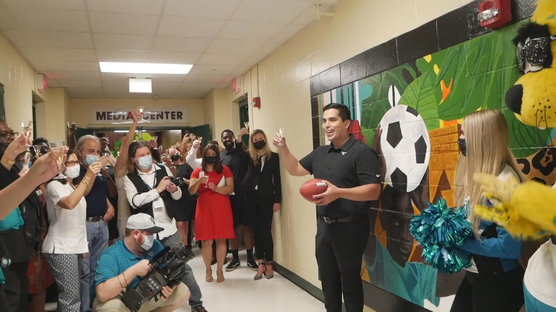 The mural, unveiled at duPont Middle School Tuesday,  features five figures of varying skin tones and other symbols to represent the diversity of Hispanic culture.
