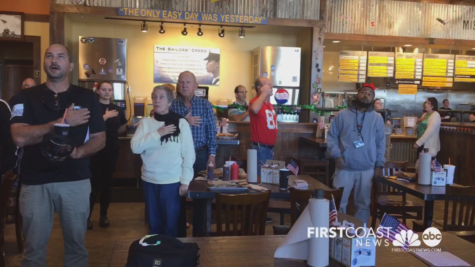 Customers and employees at Mission BBQ take a moment out of their lunch to sing the National Anthem. Though they do this every day, they are honoring those who lost their lives at Pearl Harbor. Today only, WWII vets eat free at all Mission BBQ locations!