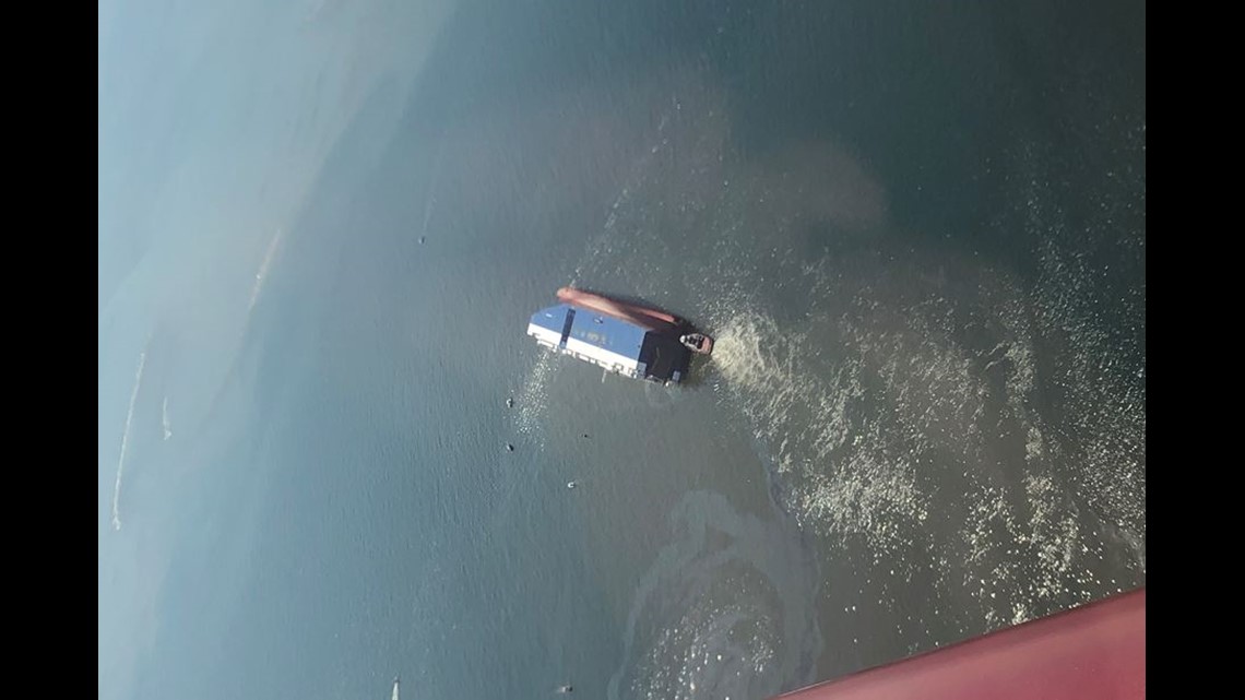 PHOTOS Aerial view of overturned cargo ship leaking fluid into the St