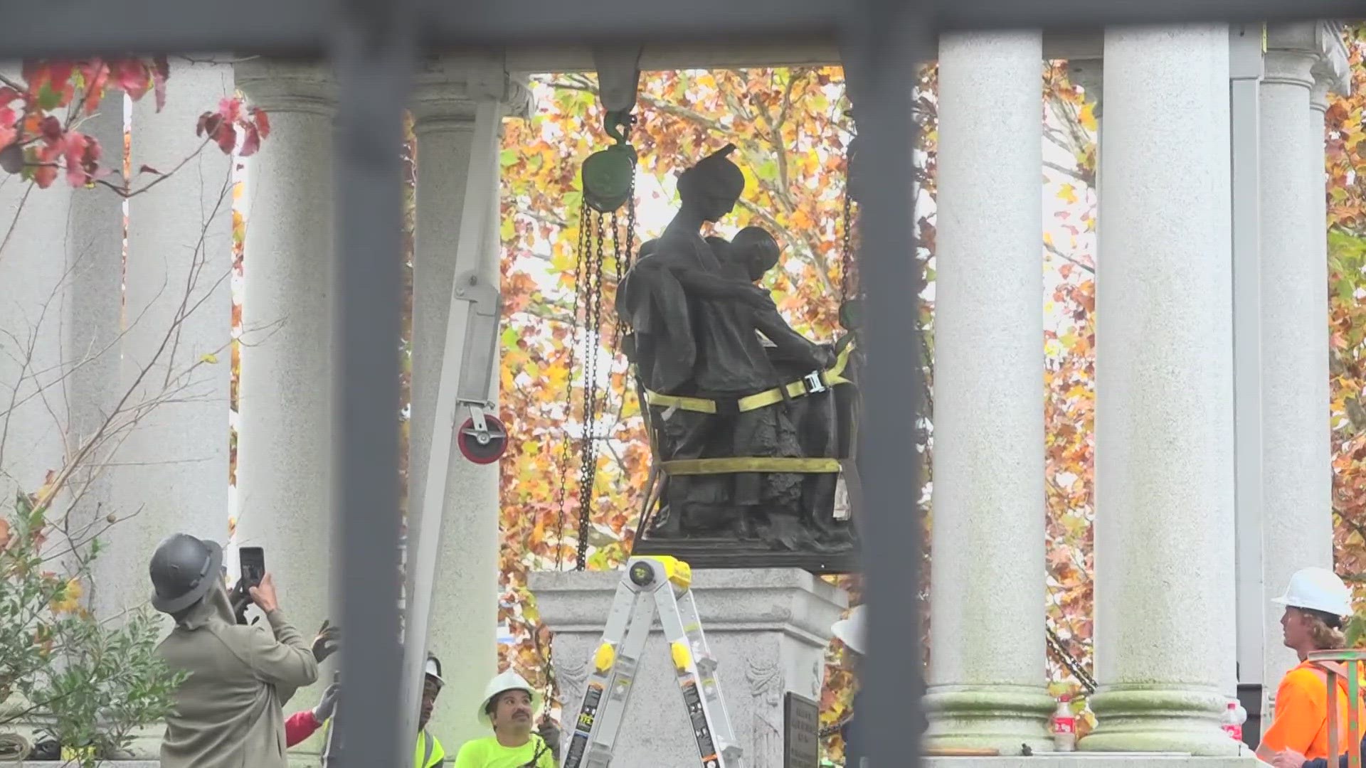 Several onlookers could be seen at Springfield Park in Downtown Jacksonville Wednesday morning, watching construction crews remove a Confederate monument.