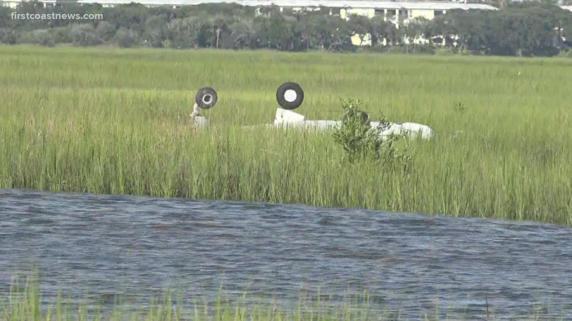 The plane flipped upside down in a marsh several yards away from the runaway. Investigators believe the plane was unable to gain altitude on the runway.