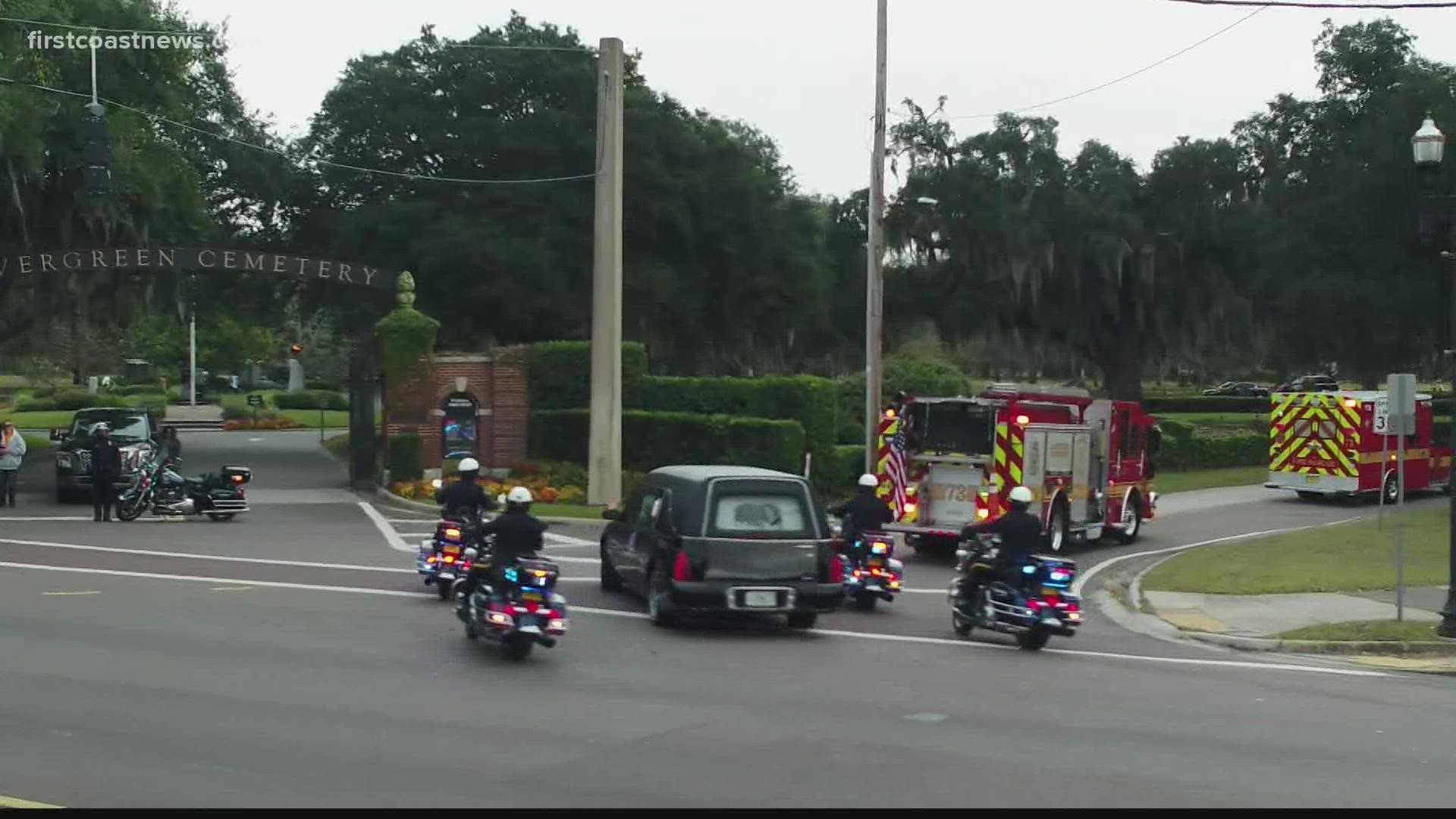 A procession of about 100 emergency vehicles, family and friends ended at the evergreen cemetery, the final resting stop for firefighter Michael Freeland.