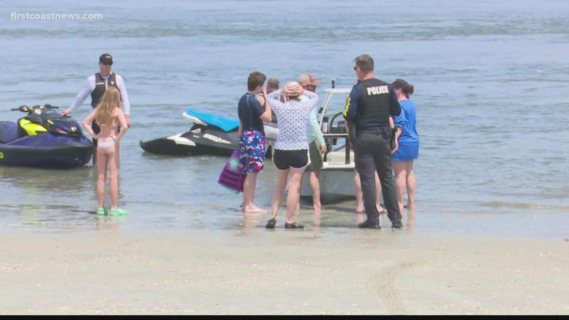 One of the jet skis flipped over to leave the man and child floating, while the second was caught on a sandbar where the man and child could stand.