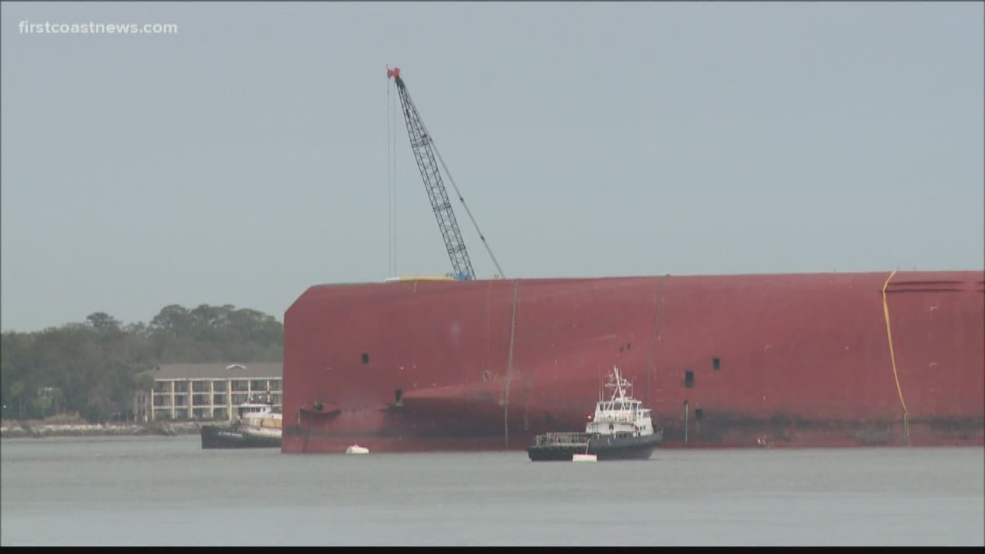 Salvage teams are working to build an environmental protection barrier around the overturned Golden Ray cargo ship in the waters off Jekyll Island.