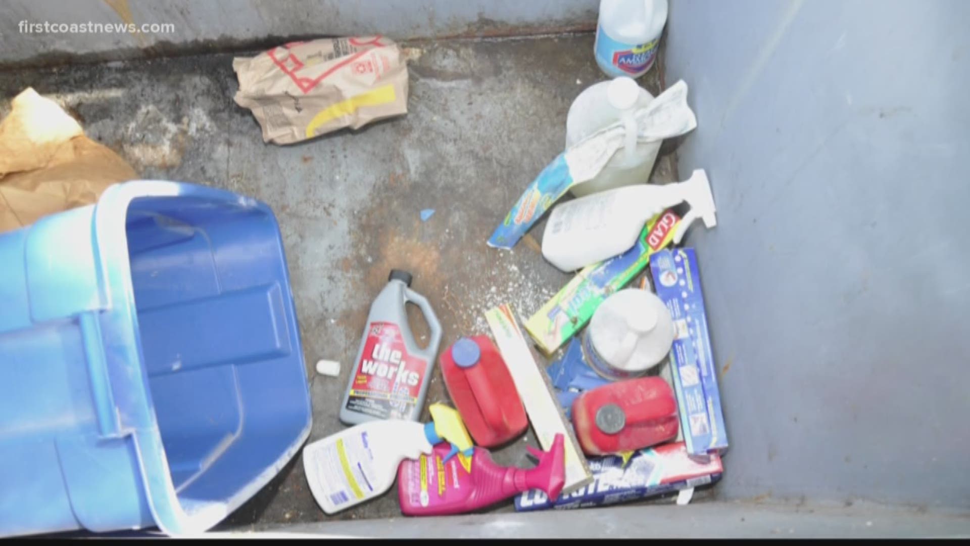 The newly released materials include photos such as a dumpster full of cleaning products and wax paper. Another photo shows a blue tarp and gray bin which have stains of some type on them.