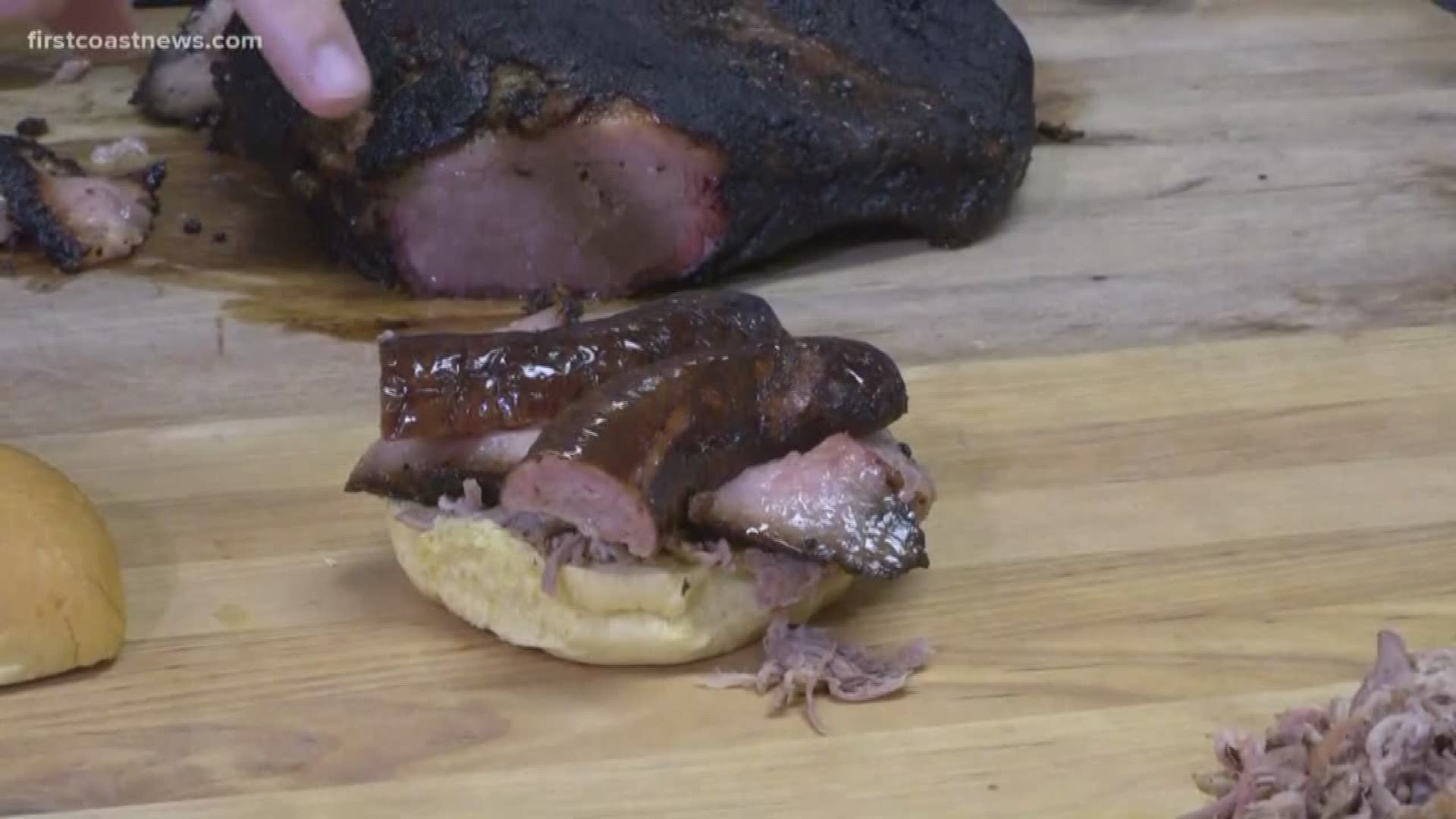 Kamrel samples a sandwich from Bearded Pig BBQ