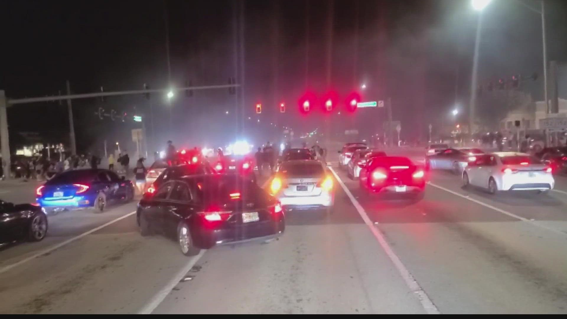 Cars were at a standstill at a Jacksonville intersection while street racers did burnouts.