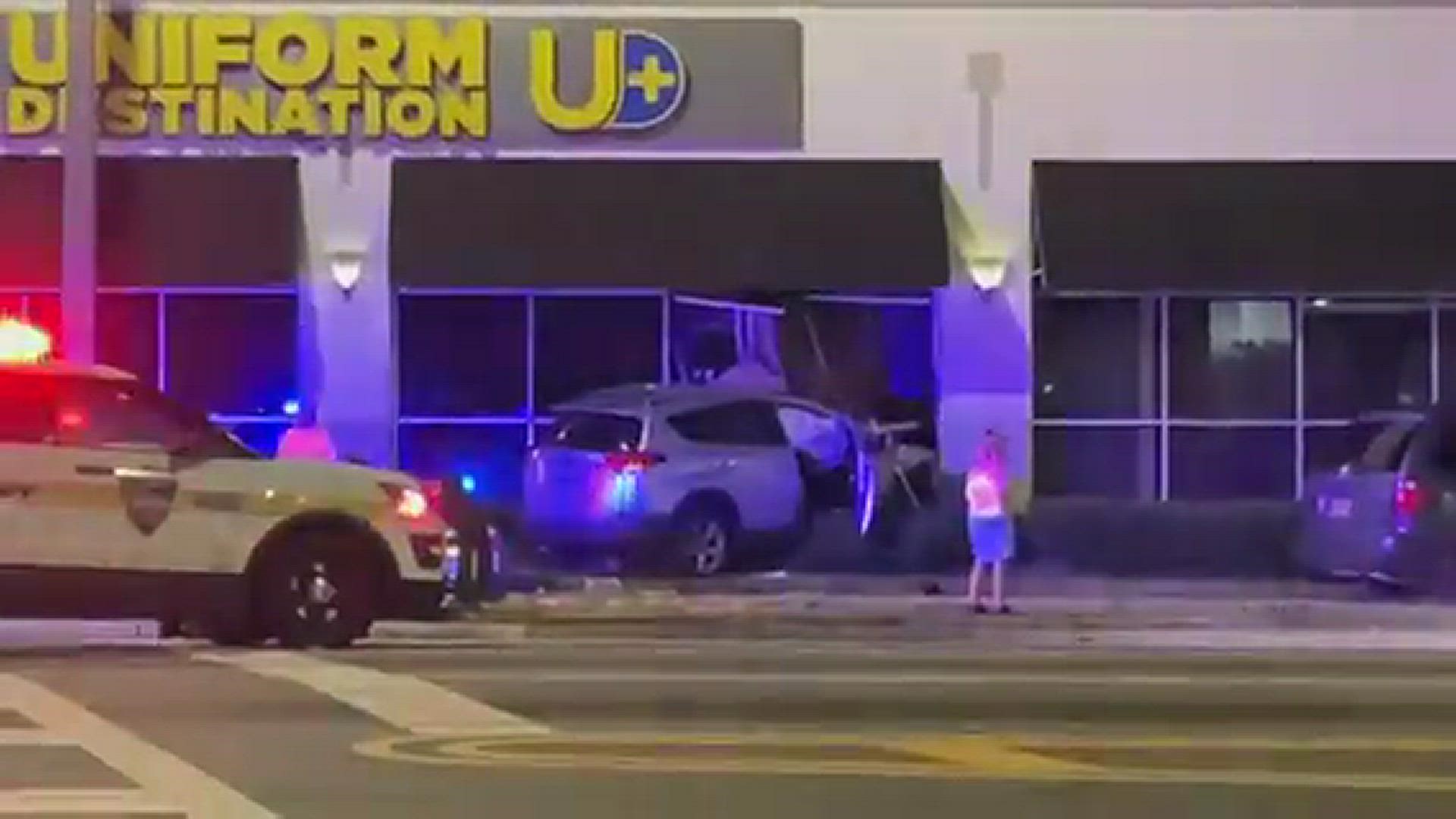 The car that crashed into Uniform Destination Jacksonville is shown here, along with police cars at th escene.
Credit: JMassa