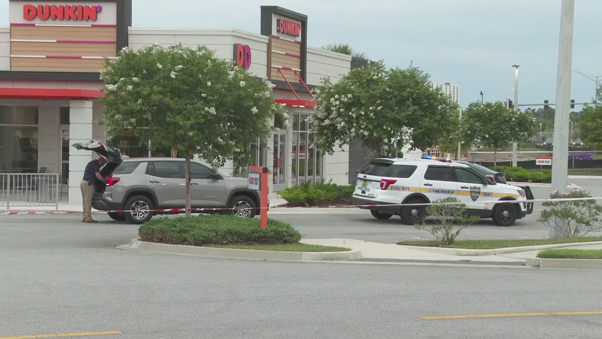The woman was attempting to get out of the vehicle when she was shot, police said. 