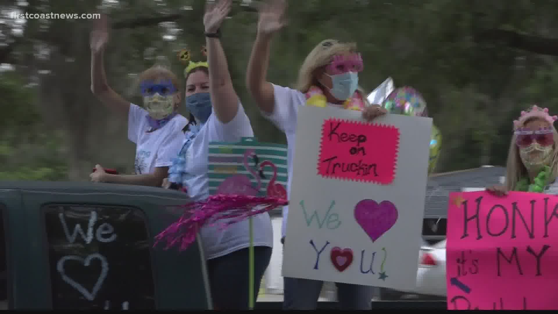 Dozens of vehicles, including fire trucks, police cruisers, motorcycles and decorated cars circled the nursing center honking their horns and cheering for residents