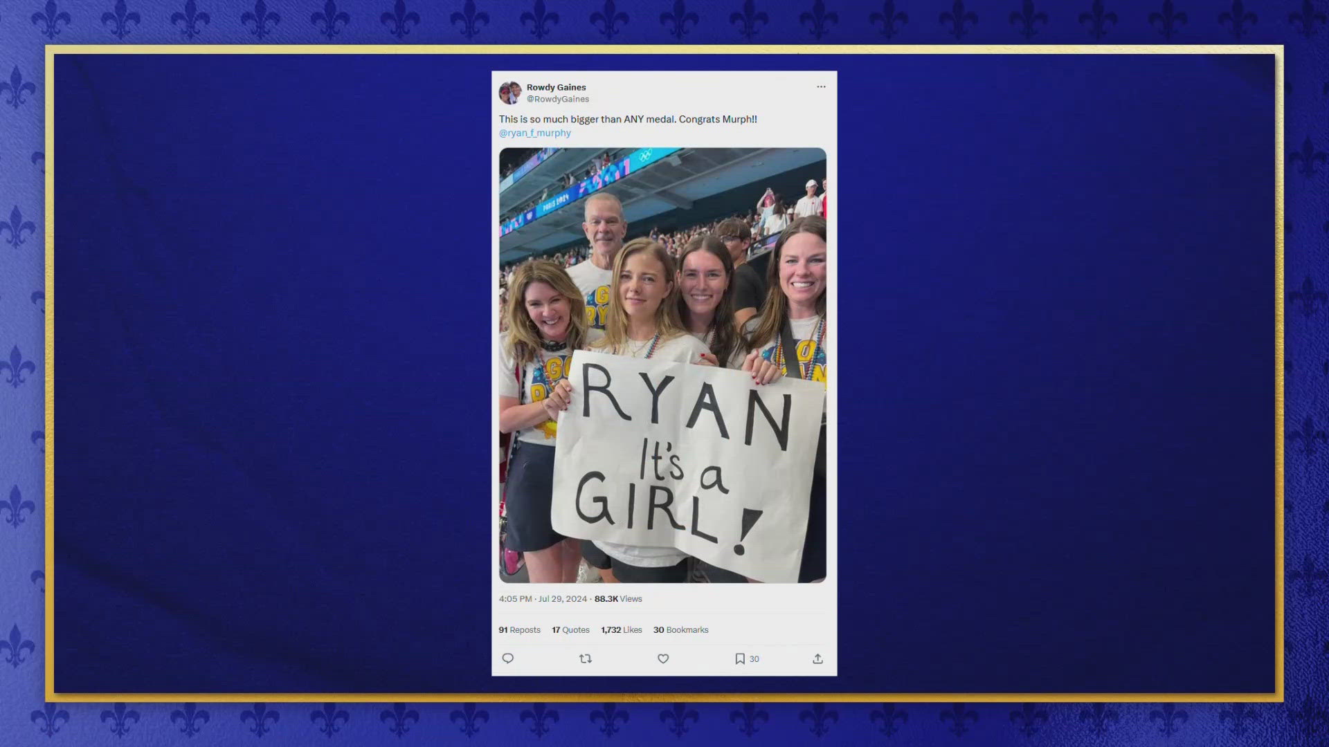 As the Olympian circled the pool deck, his wife was holding up at sign to reveal to him the gender of their baby due in January.