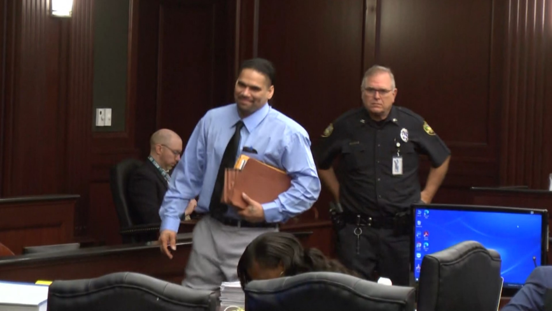 Johnathan Quiles, 33, walks in court smiling on Sept. 14 as opening statements begin in his death penalty trial. He is accused of killing his niece after raping her.