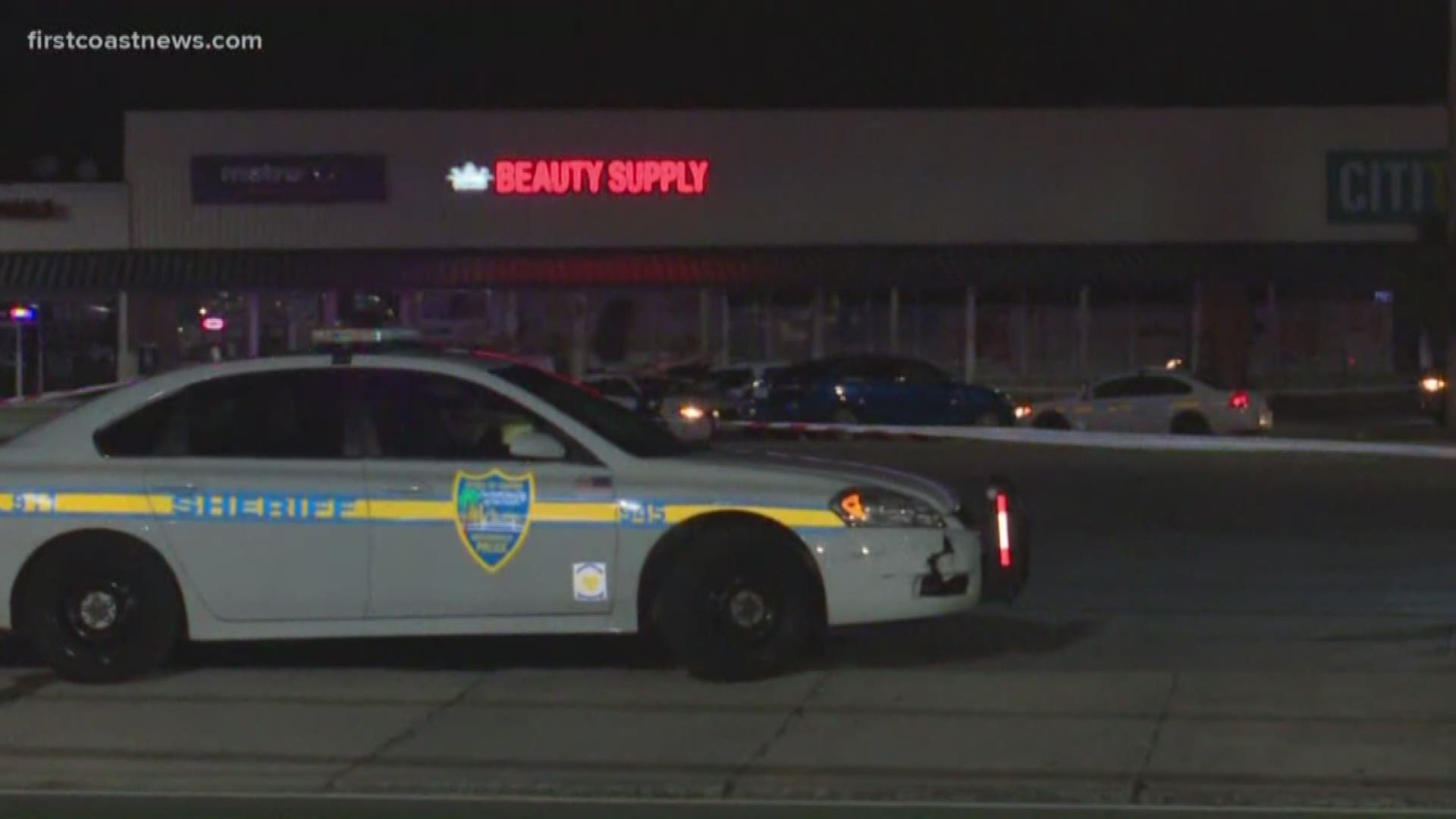 A man was shot dead inside a vehicle at a Jacksonville shopping plaza while two juveniles sat in the backseat.