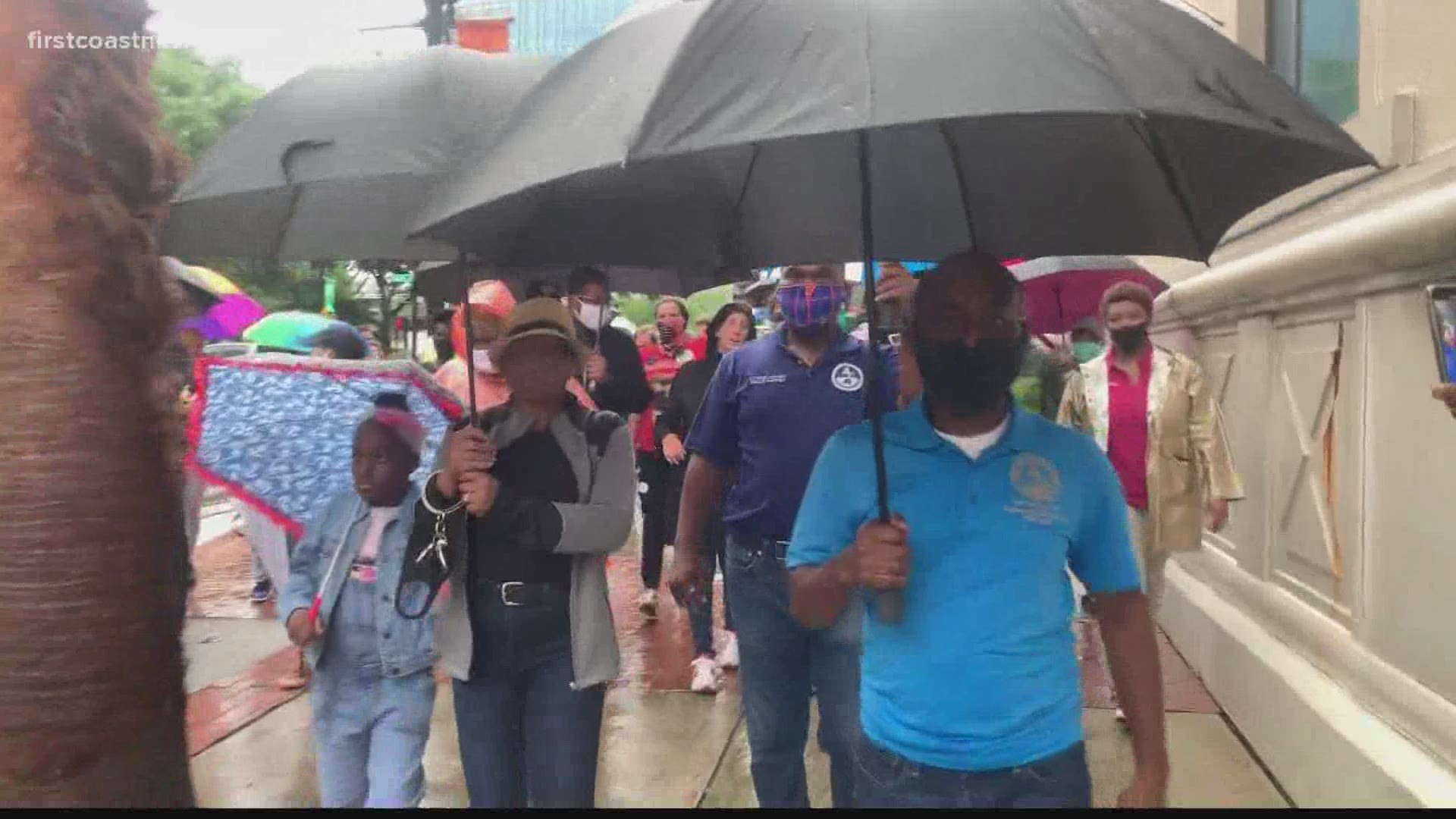 Jacksonville city leaders held a solidarity march downtown despite the rain.
