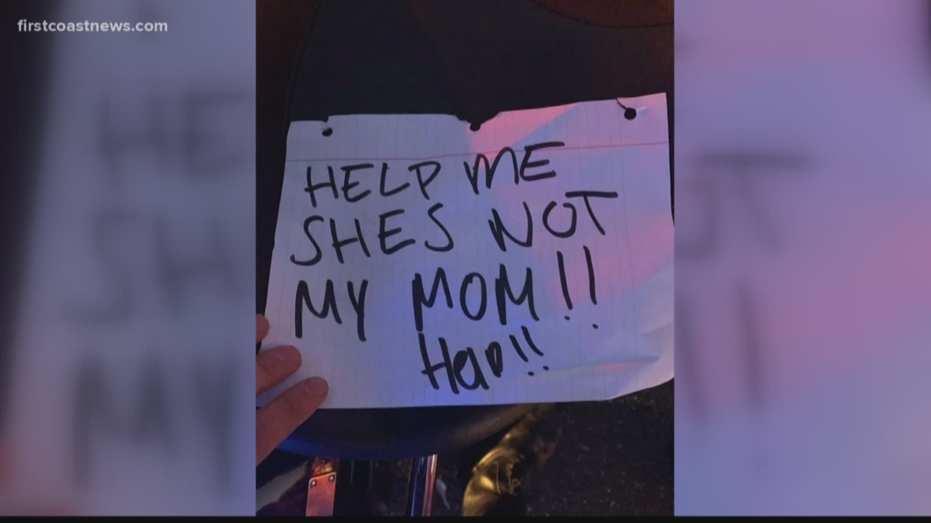 The handwritten sign said, "help me she's not my mom!! help!!"