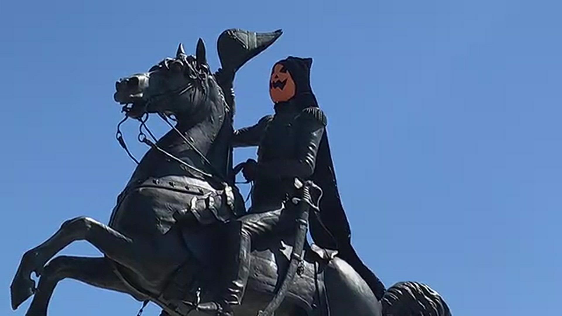 The tribute to Andrew Jackson is now wearing a pumpkin head mask and cape, as seen today on Water Street in Downtown Jacksonville.