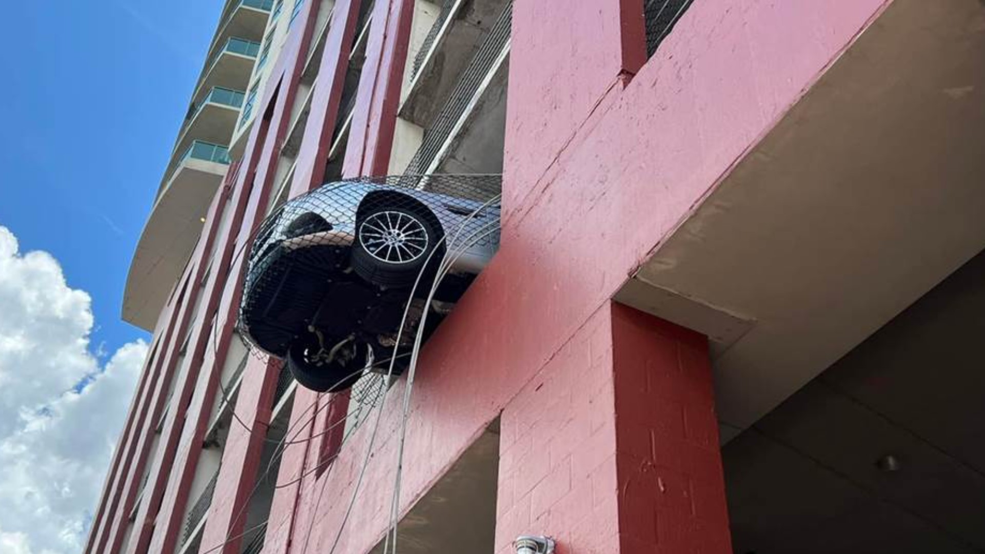 photos-car-spotted-dangling-from-parking-garage-in-north-fla