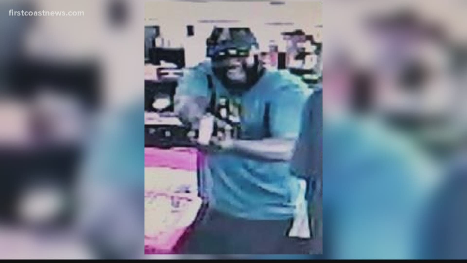 The suspect is described to be a black male weighing 240 lbs., wearing a teal colored-shirt with a Jaguars logo, black shorts, black shoes, black hat, black sunglasses and equipped with a black and silver handgun.