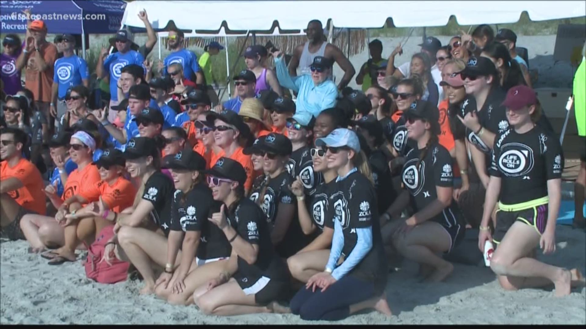 Surfboards in hand, hundreds of volunteers got into the water to help the surfers in and out.