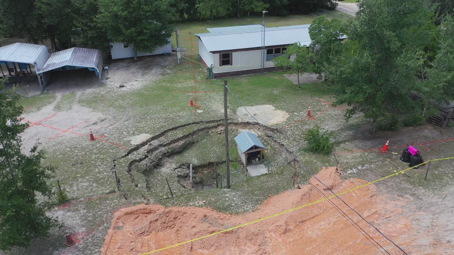 A 60-foot sinkhole in Clay County is getting even bigger, closing nearby roadways, says the Clay County Sheriff's Office.