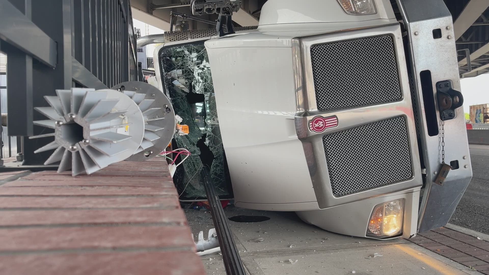 The truck traveled under a bridge on Bay Street with its back raised, causing it to hit the bridge and overturn, according to a witness of the crash.
