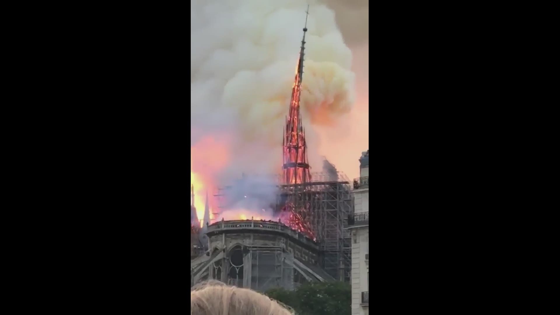 A massive fire engulfed the roof of Notre Dame Cathedral in the heart of the French capital Monday, toppling its spire and sending thick plumes of smoke high into the blue sky.