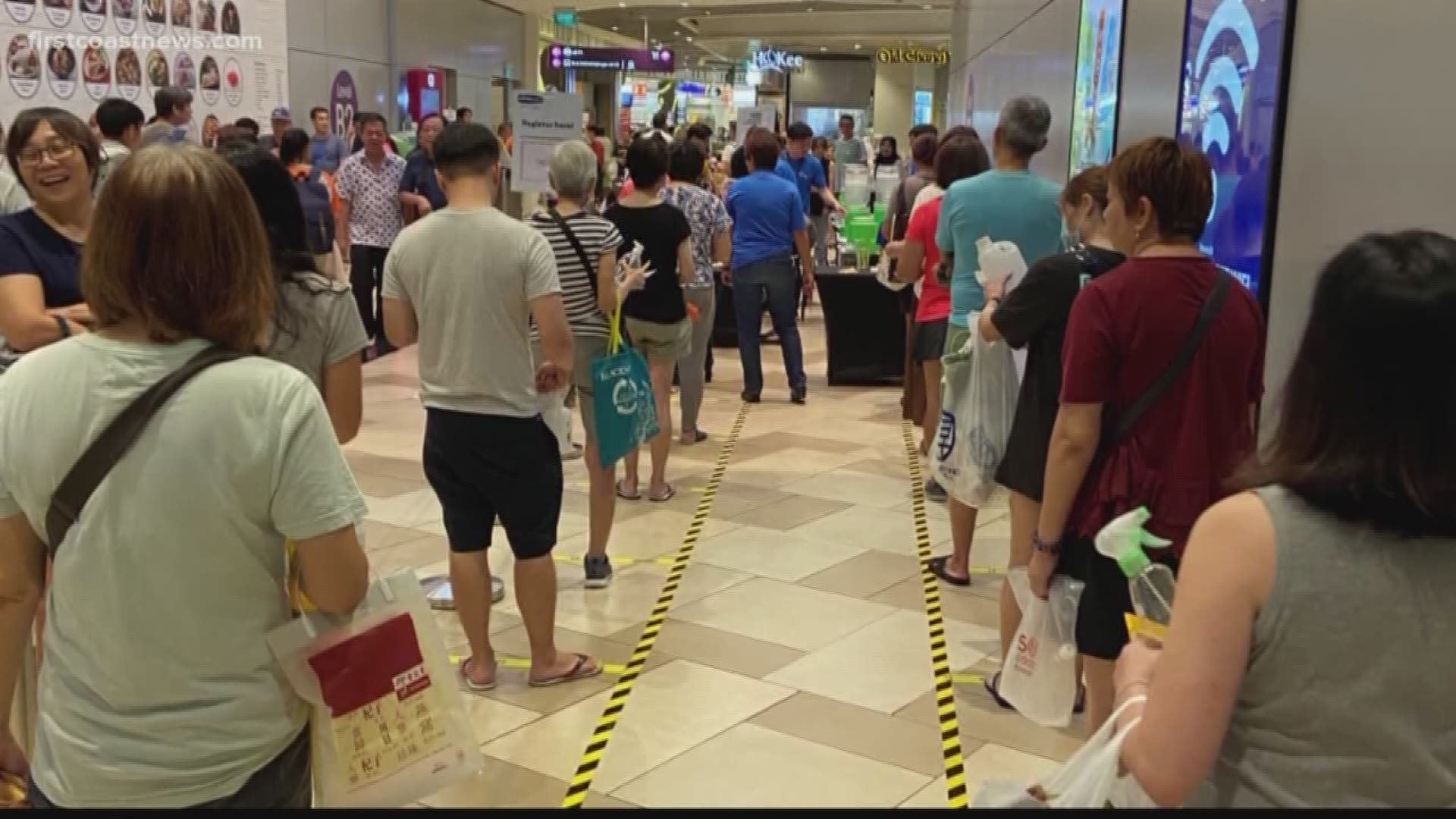 Singapore is asking people to stay at least three feet apart and is advertising social distancing recommendations at banks, malls and restaurants.