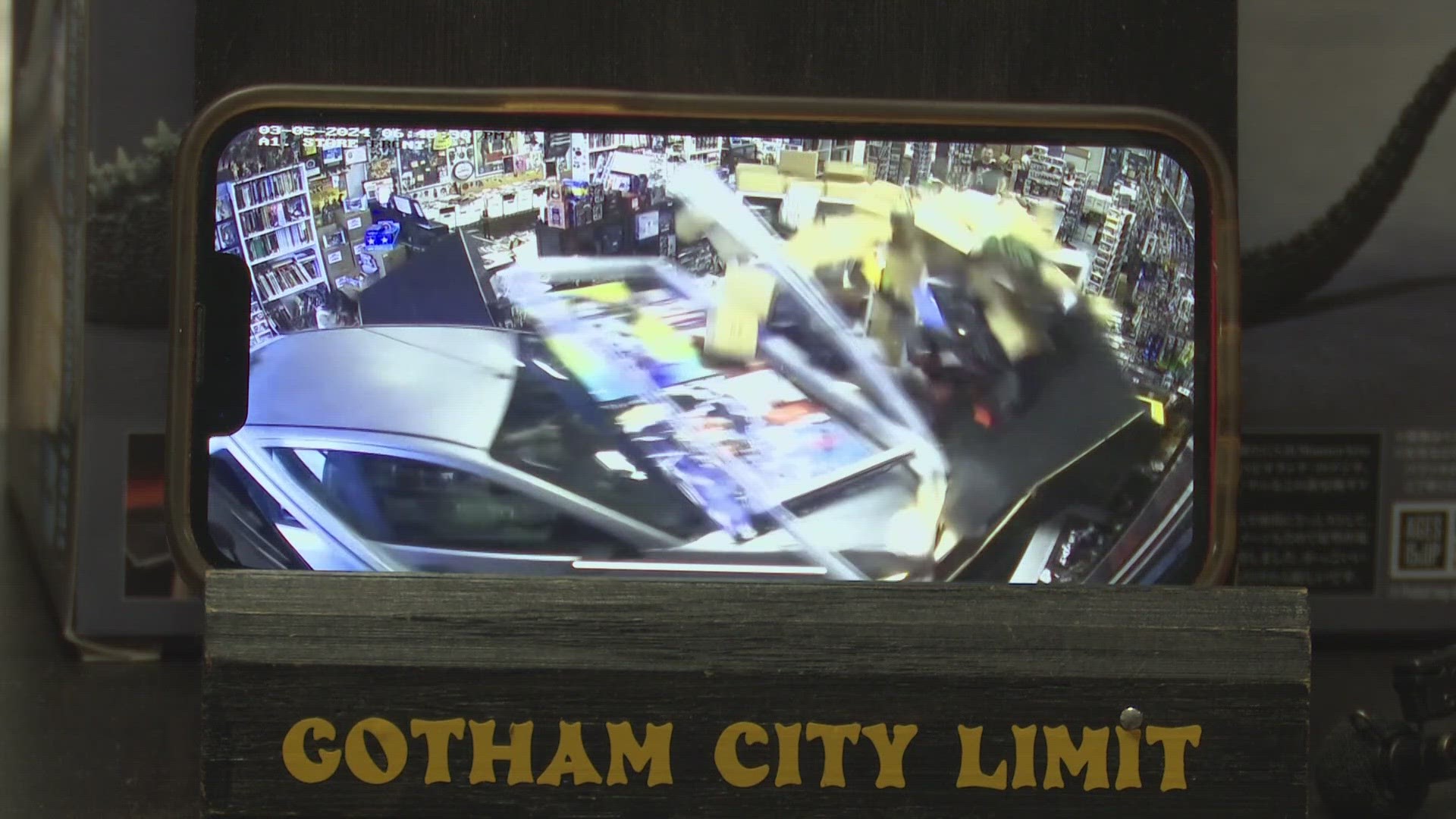 Three people were seconds and inches away from being killed by a car that drove through the front of Gotham City Limit.